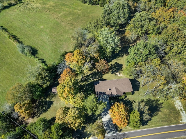 birds eye view of property featuring a view of trees