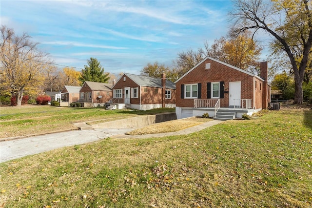 view of front of property with central AC unit and a front lawn