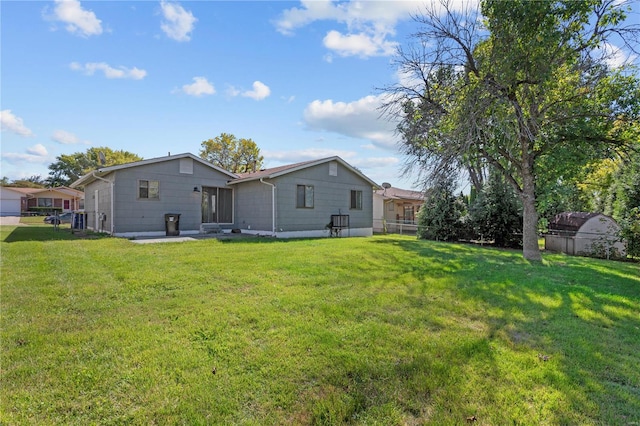 back of house featuring a yard and a patio