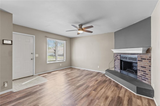 living room featuring a fireplace, ceiling fan, and hardwood / wood-style floors