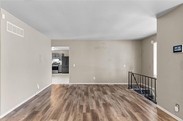 empty room with hardwood / wood-style flooring