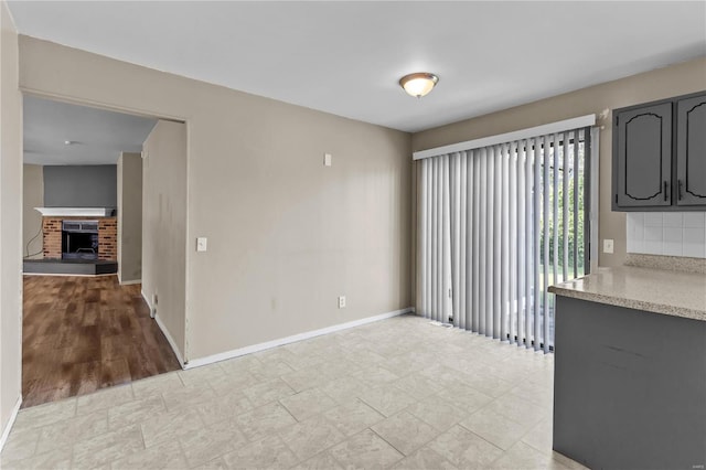 unfurnished dining area with light wood-type flooring and a fireplace