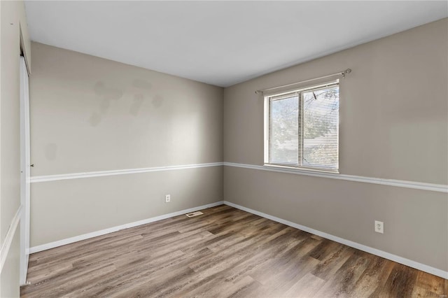 spare room featuring hardwood / wood-style floors