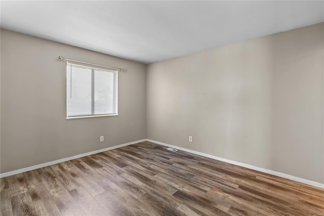 unfurnished room with wood-type flooring