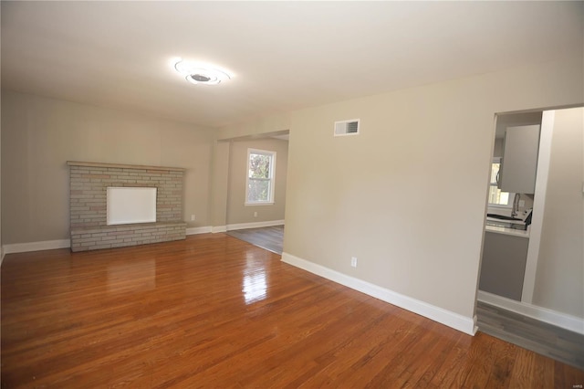 unfurnished living room featuring hardwood / wood-style floors