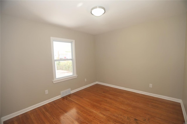 unfurnished room featuring hardwood / wood-style flooring