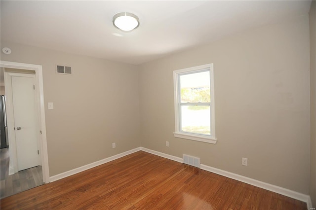 unfurnished room featuring wood-type flooring