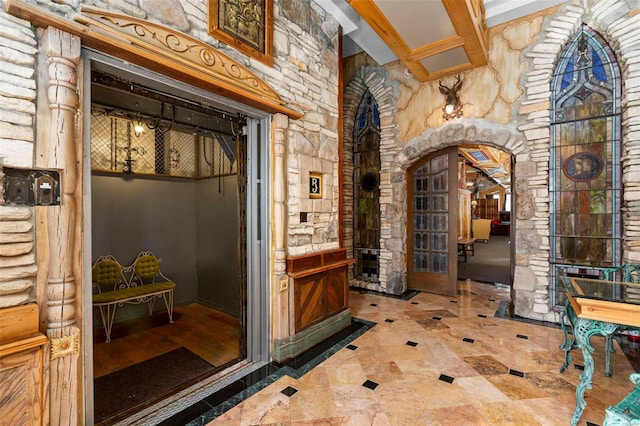 wine area with beam ceiling and decorative columns