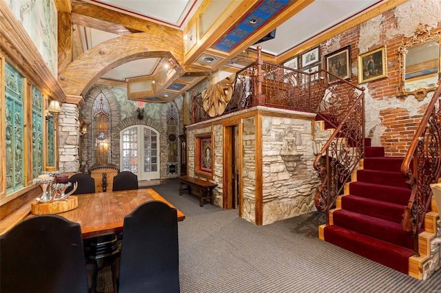 dining area featuring a towering ceiling, carpet flooring, and ornate columns