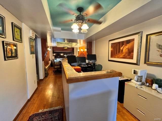 interior space featuring dark wood-type flooring and ceiling fan