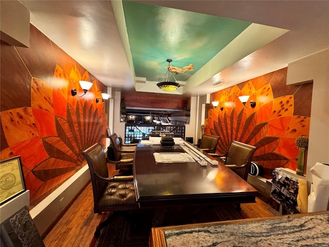 interior space with hardwood / wood-style flooring, indoor bar, and wood walls