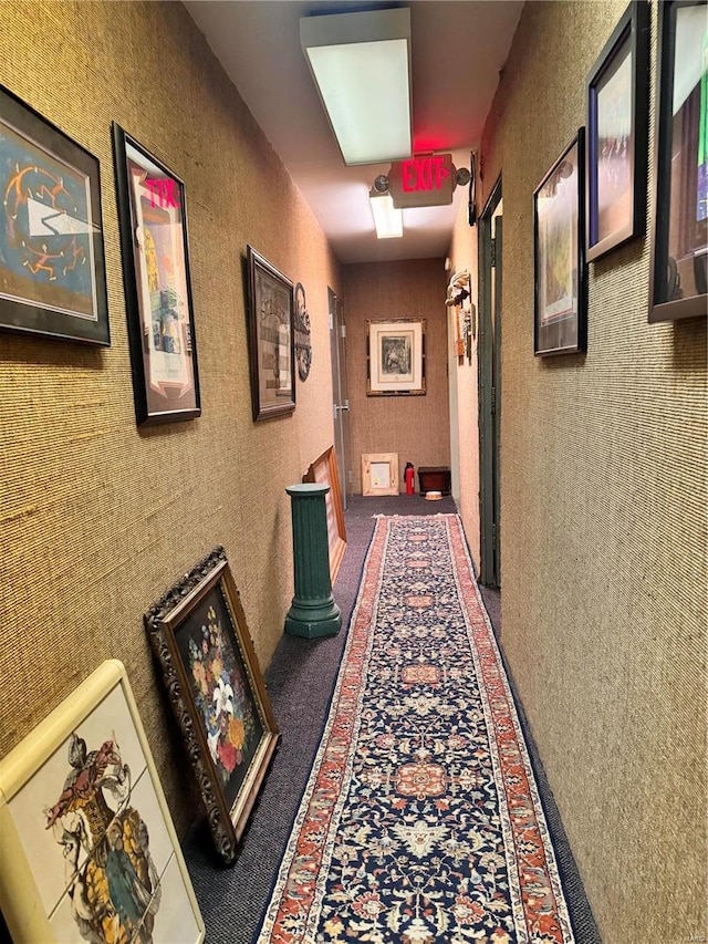 hallway featuring dark carpet