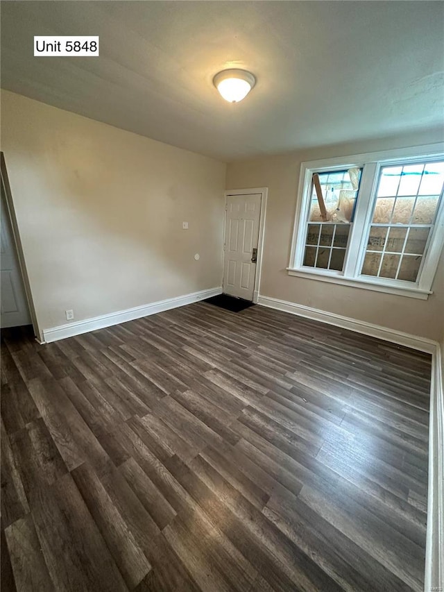 spare room featuring dark hardwood / wood-style floors