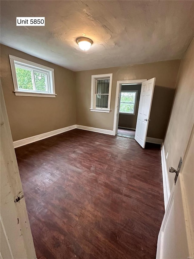 empty room featuring dark hardwood / wood-style floors