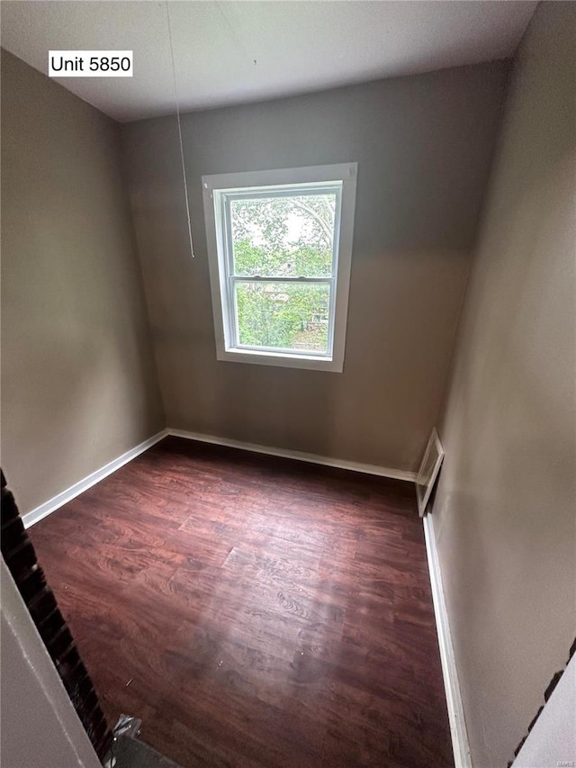 empty room with dark wood-type flooring