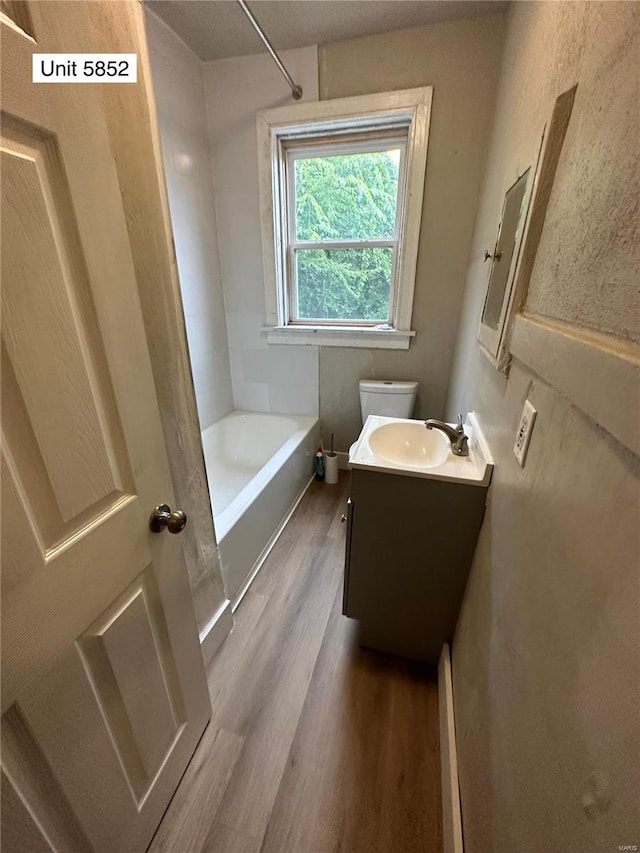 full bathroom featuring vanity, shower / tub combination, hardwood / wood-style flooring, and toilet