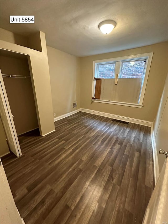 interior space with a closet and dark hardwood / wood-style flooring