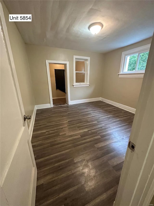 spare room with dark hardwood / wood-style flooring