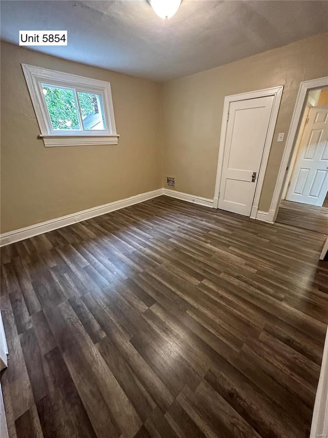 spare room featuring dark wood-type flooring