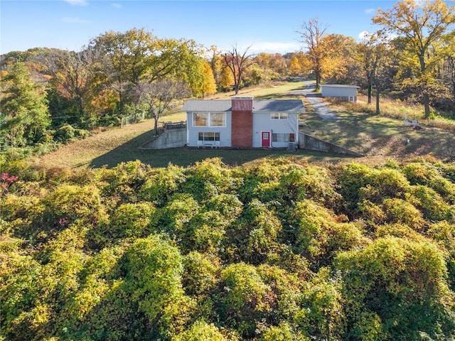 drone / aerial view featuring a view of trees