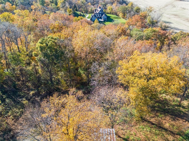 drone / aerial view featuring a wooded view