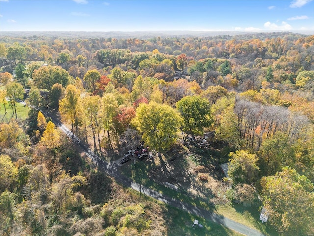 drone / aerial view with a wooded view