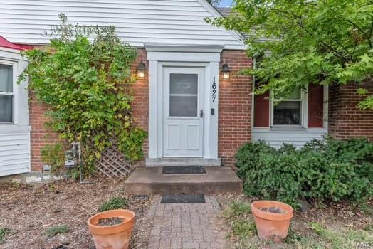 entrance to property with brick siding