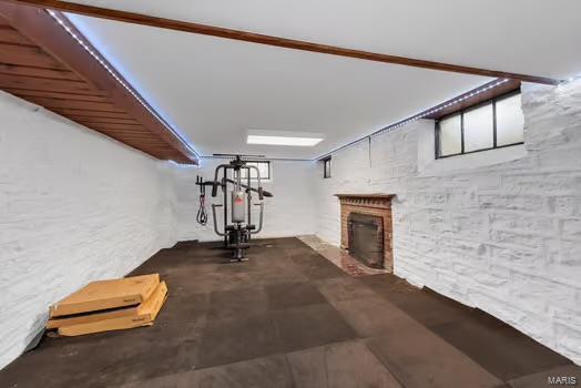 exercise room featuring a fireplace