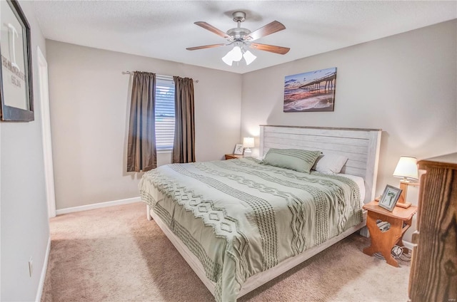 carpeted bedroom featuring a textured ceiling and ceiling fan