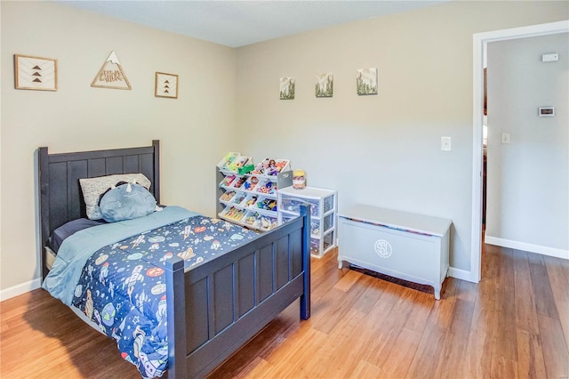 bedroom with hardwood / wood-style flooring