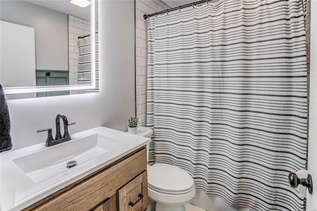 bathroom featuring vanity, toilet, and a shower with shower curtain