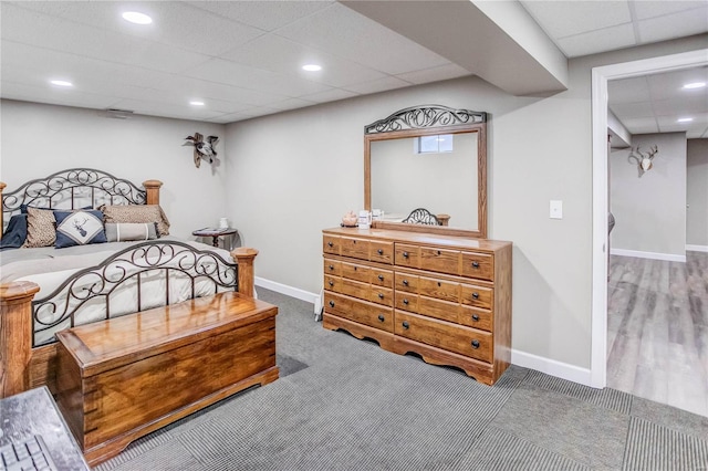 bedroom featuring a paneled ceiling and hardwood / wood-style flooring