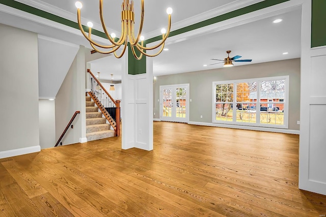 unfurnished living room with ceiling fan, ornamental molding, and light hardwood / wood-style floors