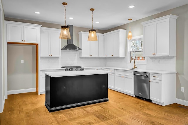 kitchen with pendant lighting, wall chimney exhaust hood, dishwasher, and white cabinets