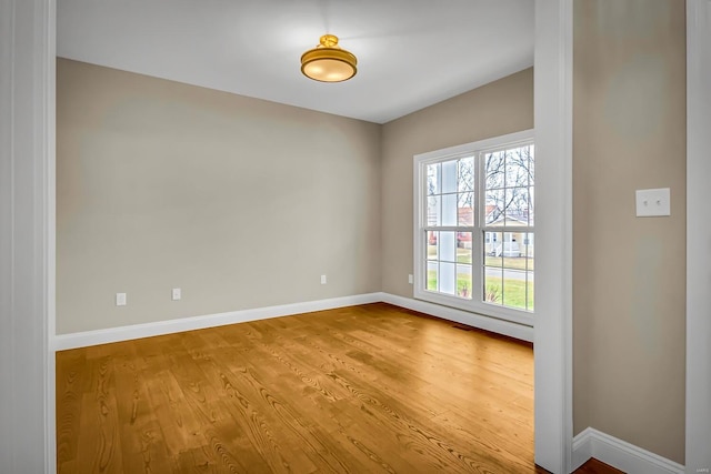 unfurnished room with hardwood / wood-style floors