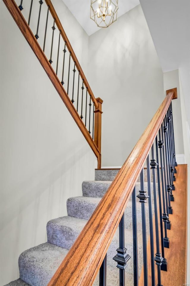 stairway with a chandelier