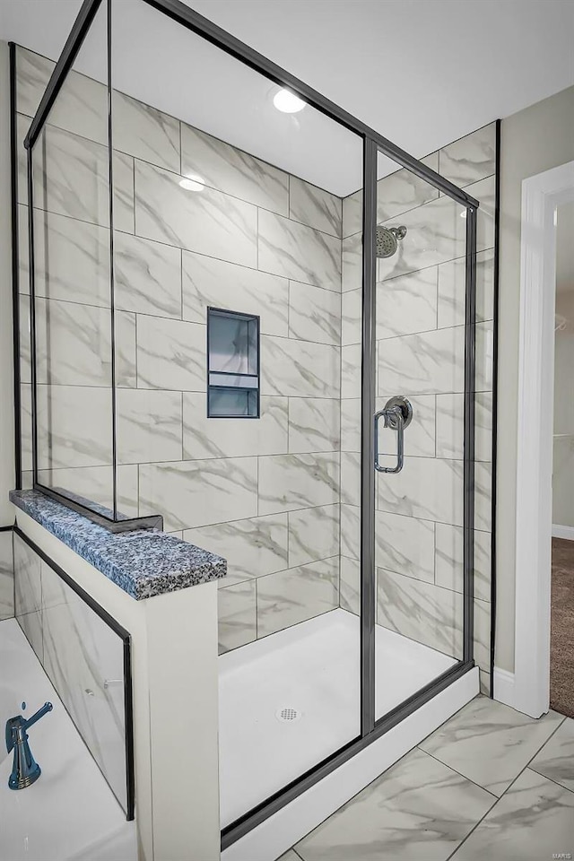 bathroom with a shower with door