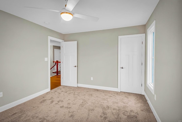 unfurnished bedroom with carpet floors and ceiling fan