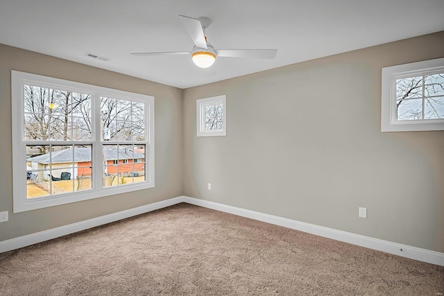 carpeted empty room featuring ceiling fan