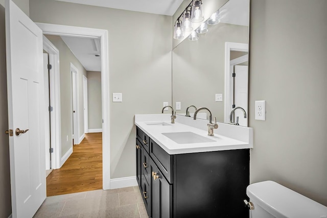 bathroom featuring hardwood / wood-style flooring, vanity, and toilet