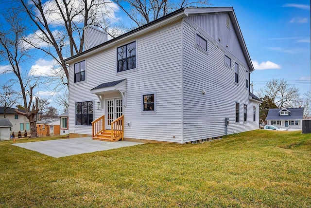 back of house with a yard and a patio