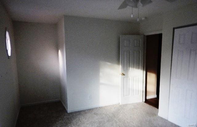 carpeted empty room with ceiling fan