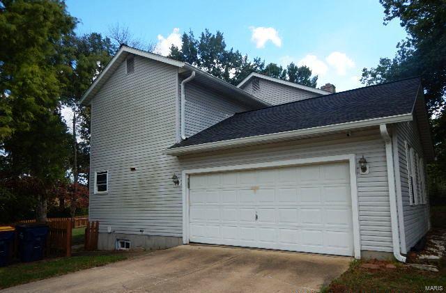 view of property exterior with a garage