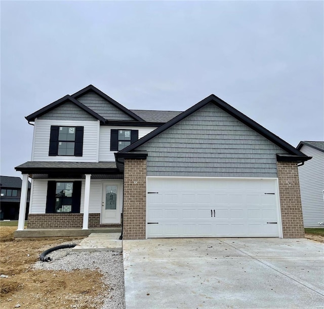 view of front of house featuring a porch and a garage