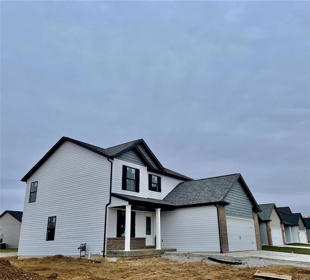 view of front of house with covered porch and a garage