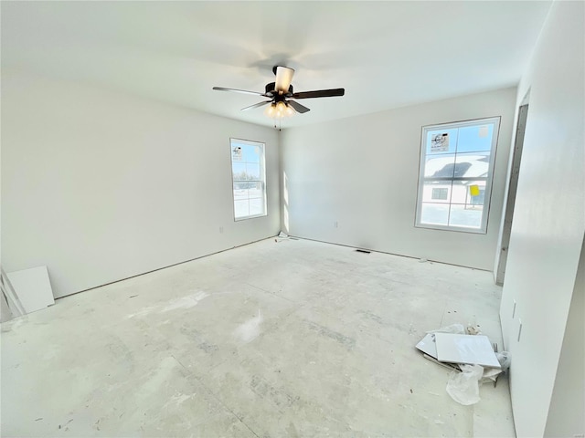 spare room with a wealth of natural light and ceiling fan