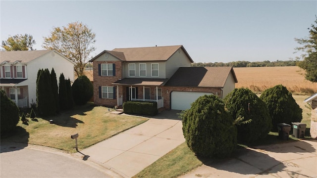 view of front of house with a front yard and a garage