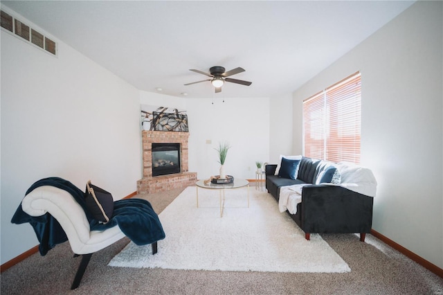 living room featuring a fireplace, ceiling fan, and carpet floors