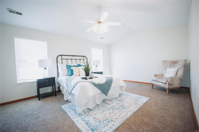 bedroom with ceiling fan, lofted ceiling, and carpet flooring