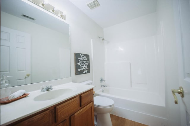 full bathroom featuring wood-type flooring, vanity, toilet, and shower / washtub combination